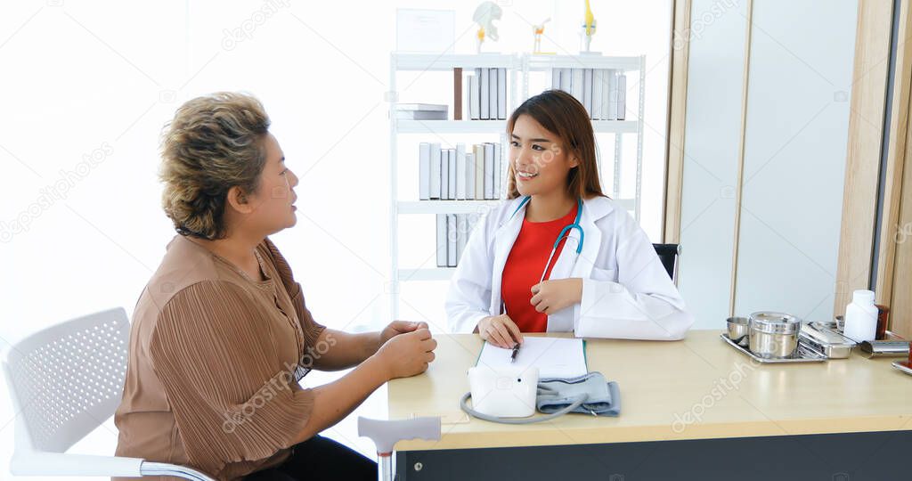 Doctor meeting and explaining medication to old woman patient  at Hospitals