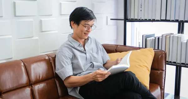 Senior Asian Man Reading Book Sofa Living Room Home Portrait — Stock Photo, Image