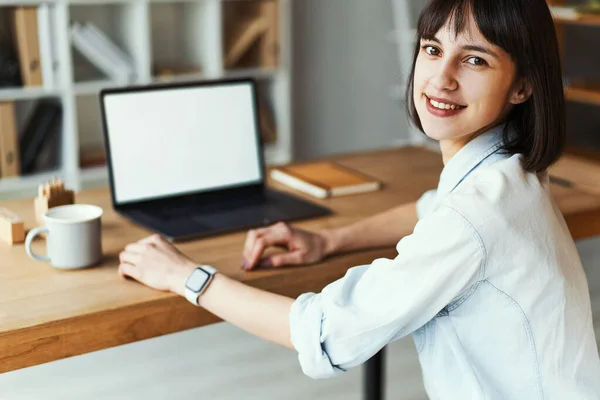 Portrait of pretty smiling woman with laptop