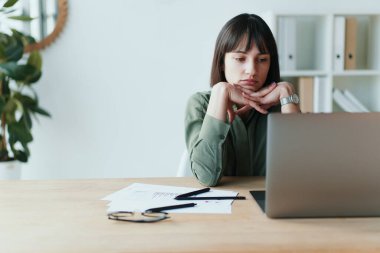 Frustrated brunette female freelancer has just got bad news