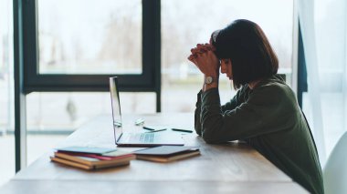 Side view of tired exhausted at work young businesswoman