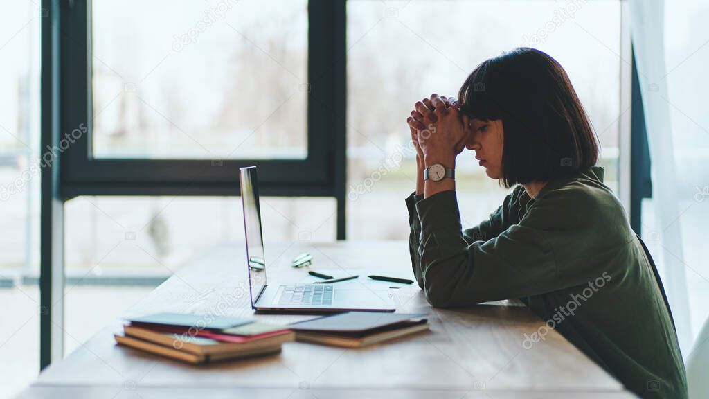 Side view of concentrated at work confident young woman