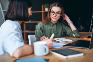 Happy pretty businesswomen having a meeting in office