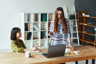 Two pretty businesswomen having a meeting in office