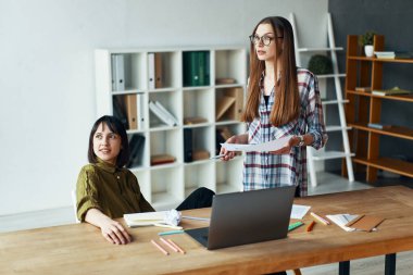 Two happy dreamy businesswomen having a meeting in office