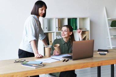 Happy pretty businesswomen having a meeting in office