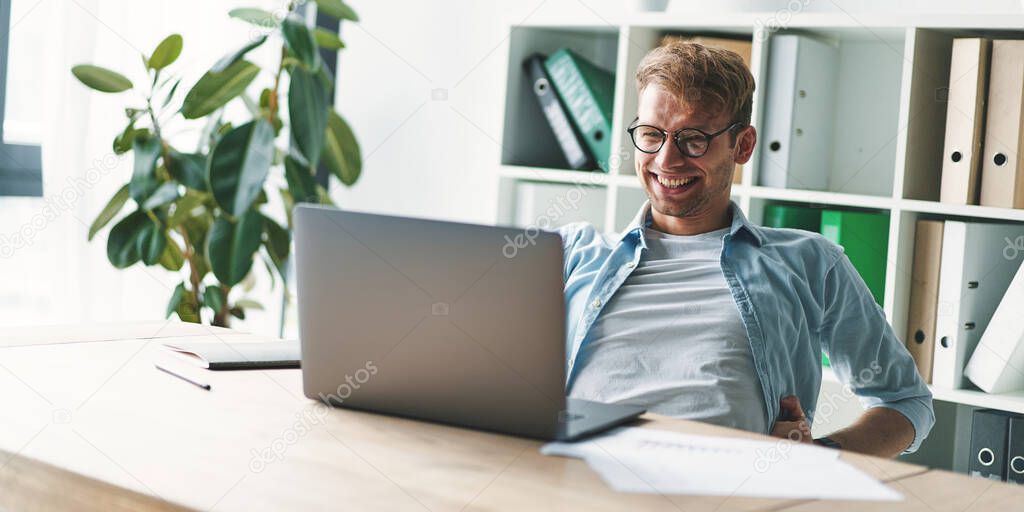 Smiling young man working at home