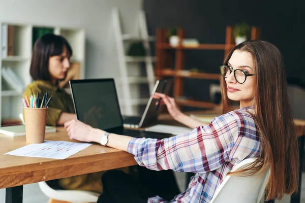 stock image Two young pretty women designers working from home using laptops