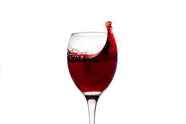 Bicchiere da vino con gocce spruzzate di vino rosso — Foto Stock