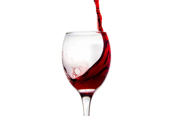 Wineglass with splashing drops of red wine — Stock Photo, Image