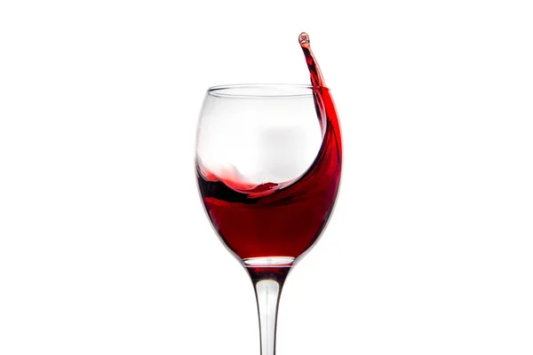 Wineglass with splashing drops of red wine — Stock Photo, Image