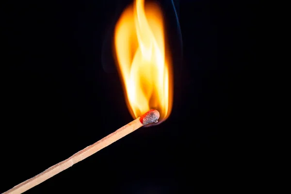 Burning match isolated on black background — Stock Photo, Image