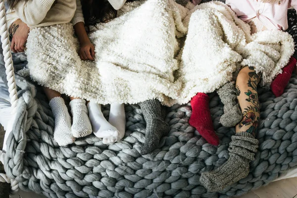 Girls lying on the bed and showing legs with socks — Stock Photo, Image