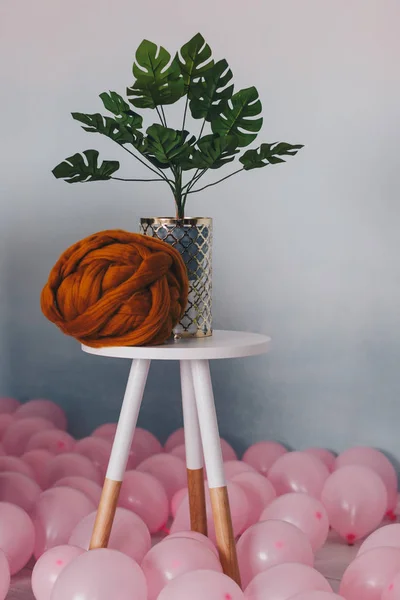 Orange merino wol ball on white table with plant — Stok Foto