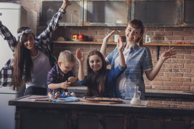 İki genç kadın ve iki çocuk mutfakta eğlenin