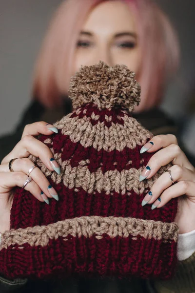 Woman holding knitted hat — Stock Photo, Image