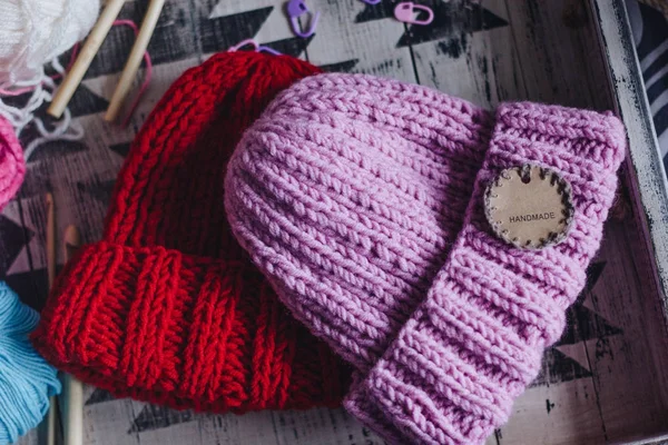 Pink and red knitted hats