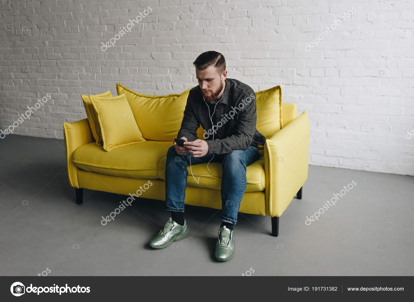 Caucasian man on yellow couch Stock Photo by ©cellardoor 191731382