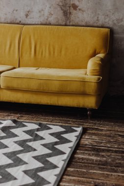 Yellow velvet couch in loft room