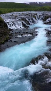 Bruarfoss Şelalesi 'nin İzlanda' daki Bruara Nehri 'ndeki manzarası. Dikey video