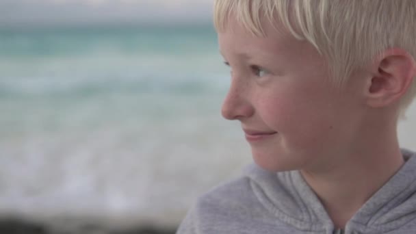 Крупный план красивой блондинки-подростка на фоне океана — стоковое видео