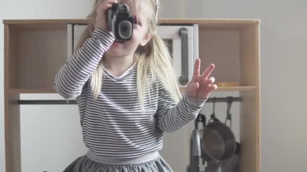 Девочка играет с игрушечным биноклем — стоковое видео