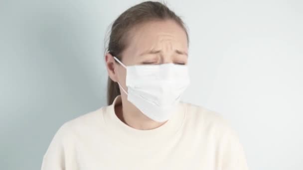 A woman in a medical mask coughs — Stock Video