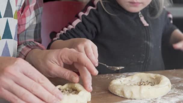 Mom and daughter make bread at home in the kitchen. — Stock Video