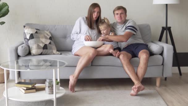 The family sits at home in quarantine and watches TV — Stock Video