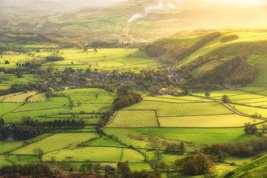 Green landscape of farm fields and village view in Peak District National Park, United Kingdom clipart