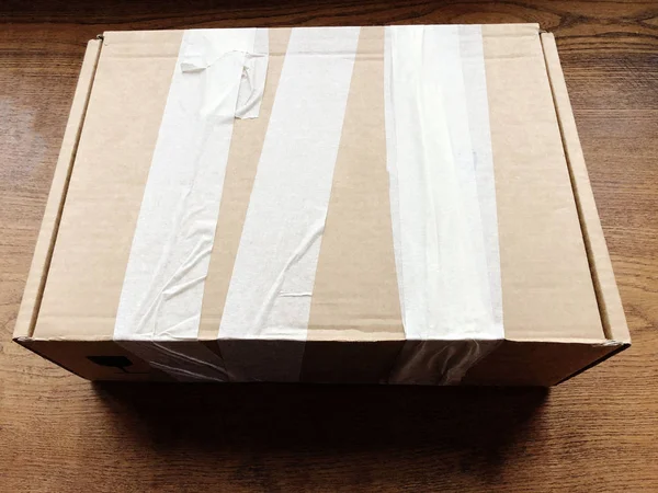 Closed Cardboard Box Covered Duct Tape Wooden Table Shipping Equipment — Stok fotoğraf