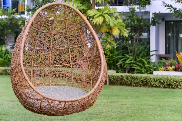 Hängender Rattanstuhl mit weißem Grau im Garten — Stockfoto