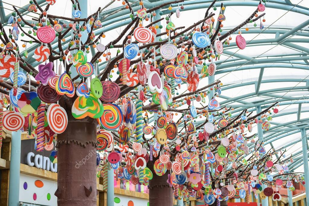 SINGAPORE, SENTOSA - SEP 06, 2014: Colorful candy model hanging on tree ...