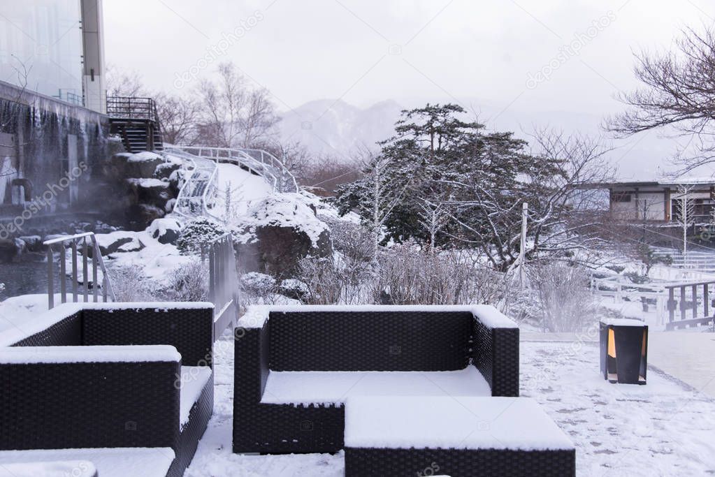 Snow covered chairs in garden