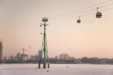 cableway lift across the Songhua River in winter, skyline of Songhuajiang river in Harbin clipart