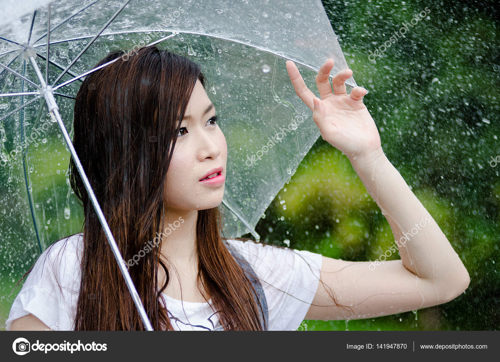 Beautiful girl is standing with umbrella among a rain 3 Stock ...