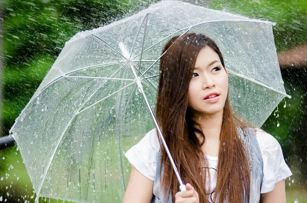 Belle fille est debout avec parapluie au milieu d'une pluie 1 — Photo