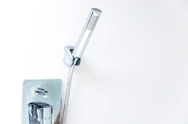 Shower hanging on wall in bathroon — Stockfoto