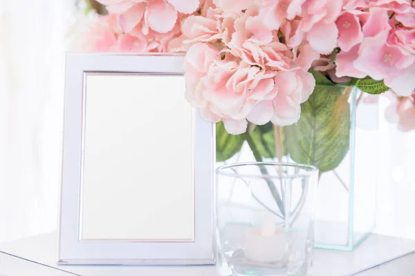 Cornice bianca sul tavolo e decorazione floreale — Foto Stock