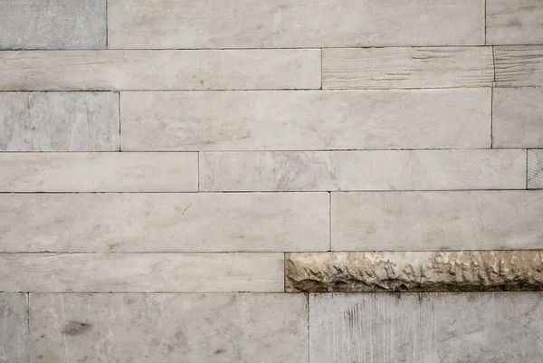 Texture of a marble gray wall with inclusions of raw marble 1