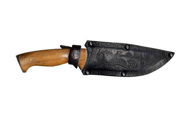 antique knife with a wooden handle and leather scabbard. embossed on the skin. isolated on white background