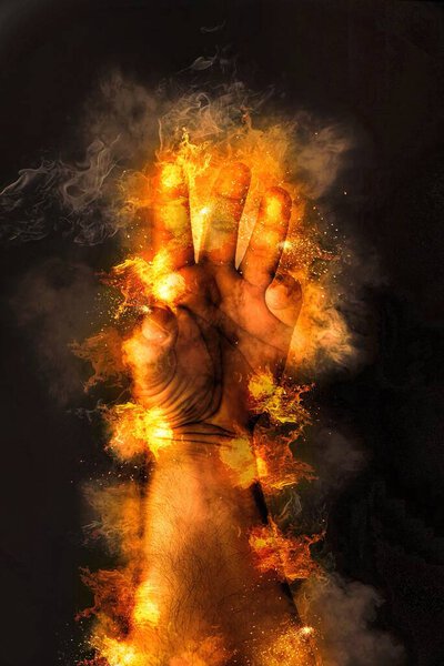 Human hand with fire background