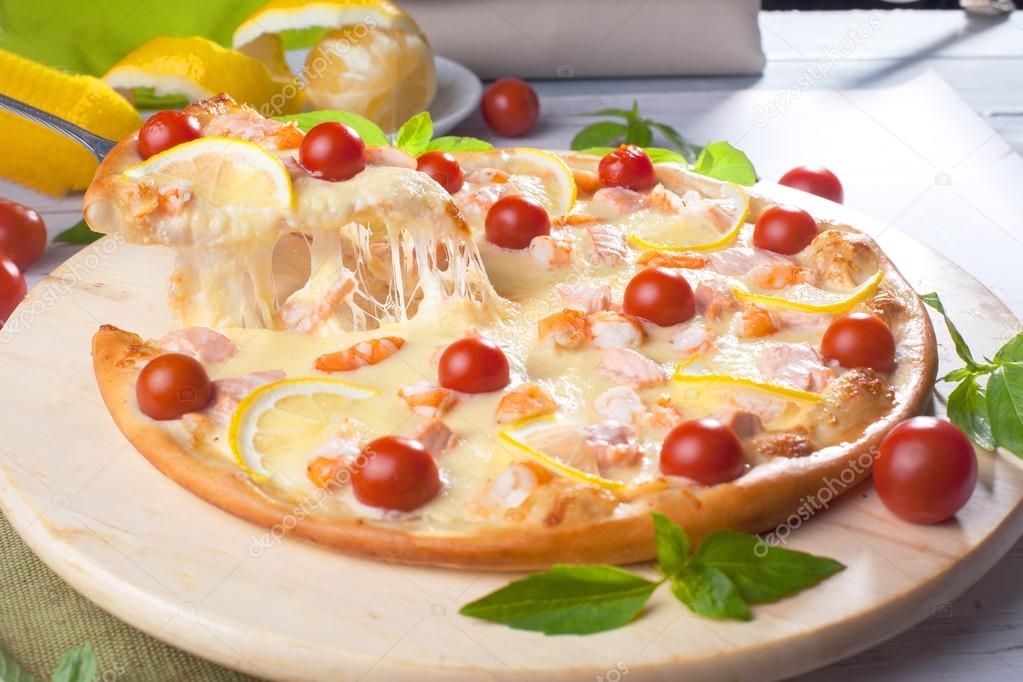Pizza with seafood red fish, salmon, shrimp, tomatoes, still life, cheese, stretches, shoulder, slice, rises