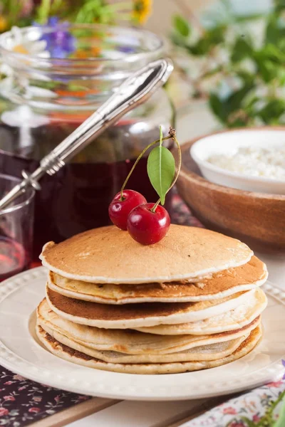 Pancakes with cherry flowers still life summer — Stock Photo, Image