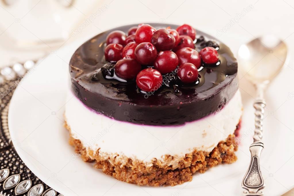 cake with cranberry jelly cream round shape berries closeup