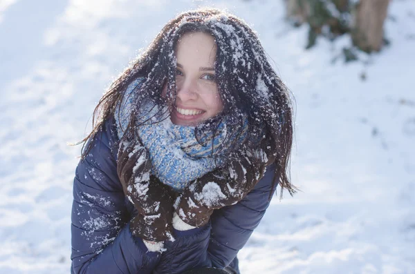 Portrait of a beautiful smiling girl with snow in her hair Royalty Free Stock Photos