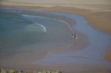 Dalgalar ve insanlar Praia da Bordeira Beach yakınındaki Carrapateira, Portekiz.