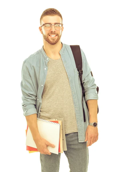 Un estudiante masculino con una bolsa de la escuela sosteniendo libros aislados sobre fondo blanco —  Fotos de Stock