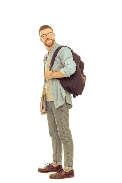 Mužský student s školní batoh drží knihy izolovaných na bílém pozadí — Stock fotografie