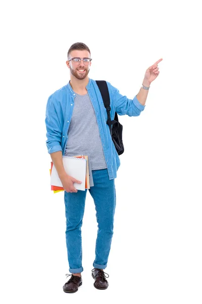 Ученик со школьной сумкой, держащий книги и указывающий на белый фон. — стоковое фото